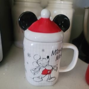 Christmas mickey mouse mug with santa hat top.